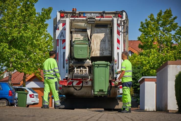 Müllwerker Samy E. von und sein Kollege von PreZero entleeren Mülltonnen in das Müllfahrzeug